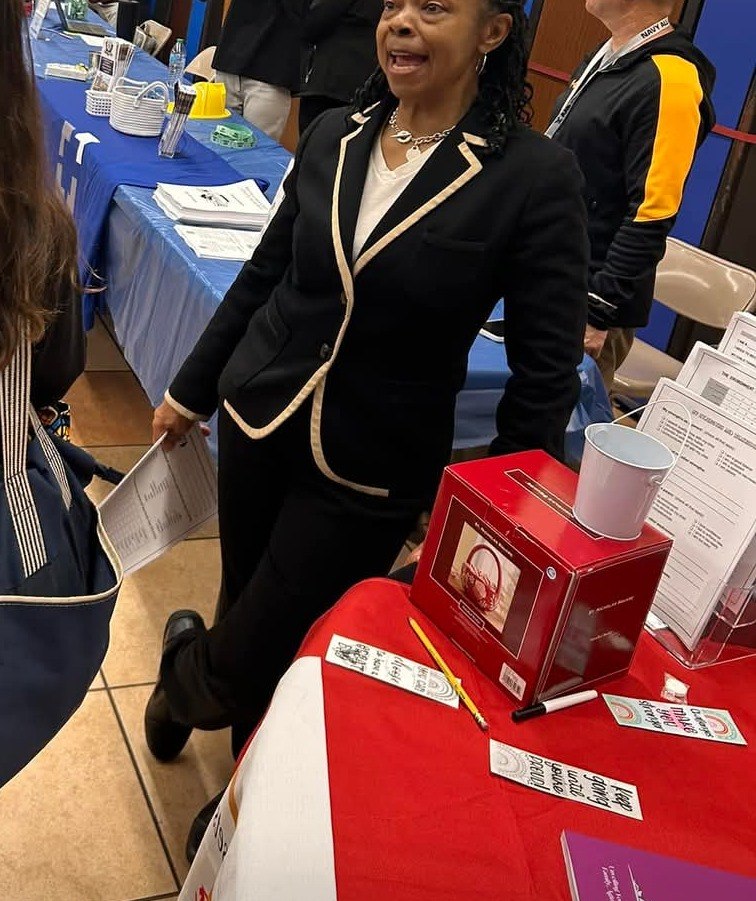 LaVerne Sease-Batie speaking with a student and family at a school event